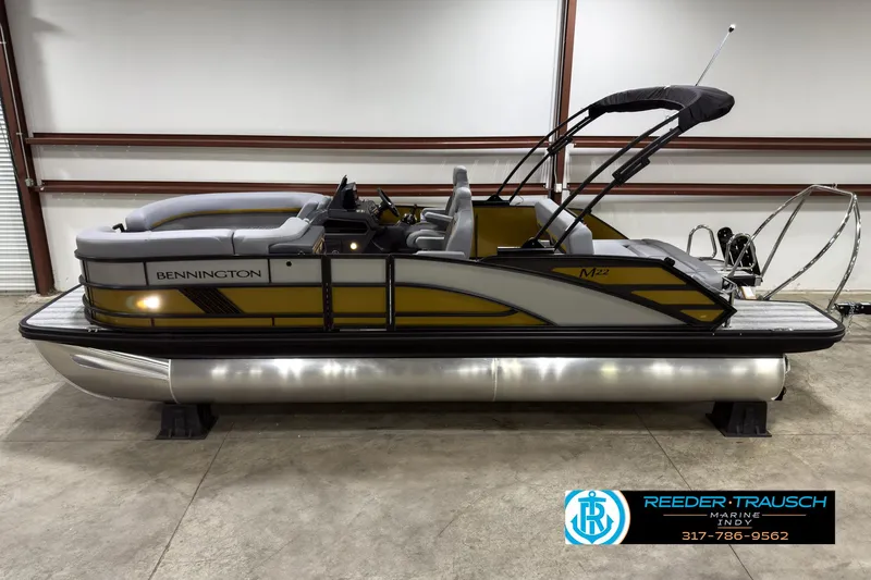 Slide: The Image of 2025 Bennington 22 MSB pontoon boat in showroom, side view. - 1