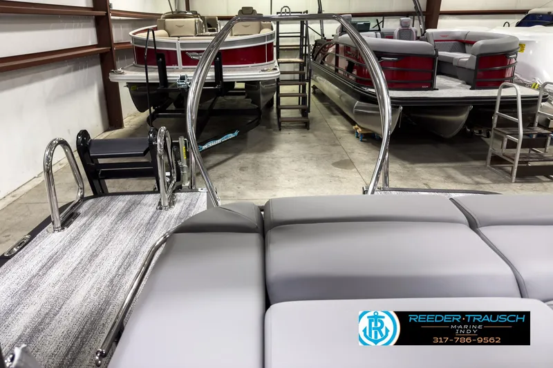 Slide: The Image of 2025 Bennington 22 MSB pontoon boat interior in showroom with other boats. - 15