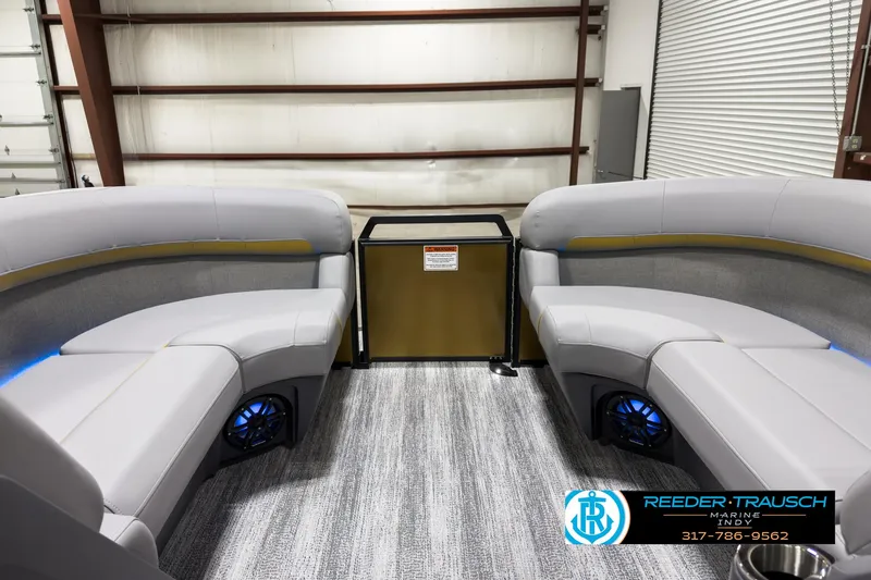 Slide: The Image of 2025 Bennington 22 MSB boat interior with gray seating and blue accent lighting. - 18