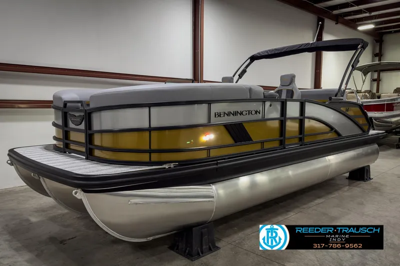 Slide: The Image of 2025 Bennington 22 MSB pontoon boat in showroom, side view. - 2