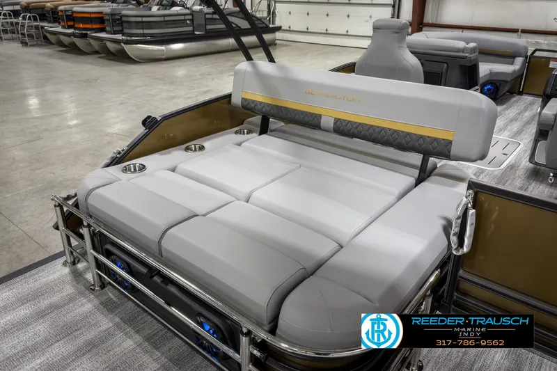 Slide: The Image of 2025 Bennington 22 MSB pontoon boat interior with plush seating in showroom. - 20