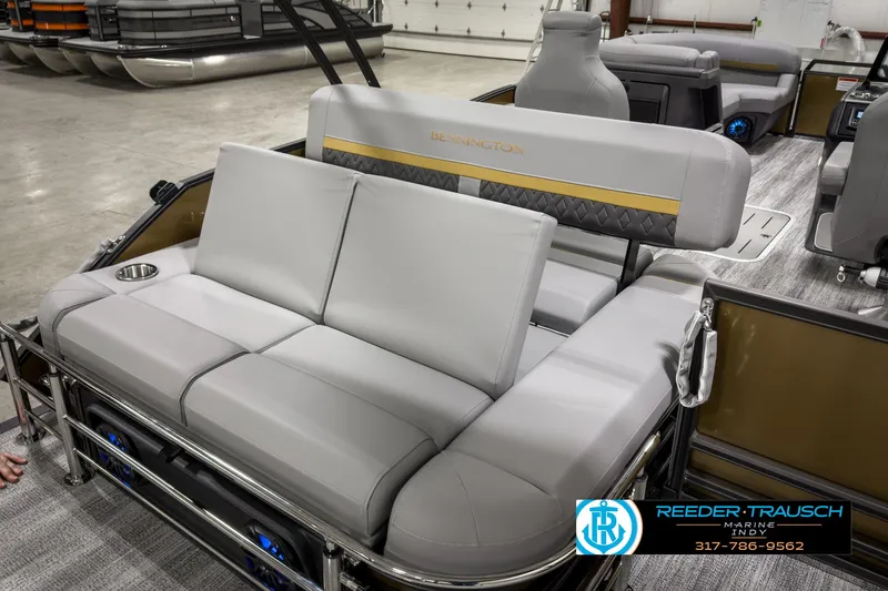 Slide: The Image of 2025 Bennington 22 MSB pontoon boat with luxurious seating in showroom. - 21