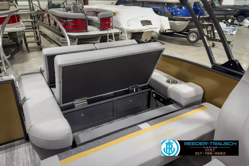 Slide: The Image of 2025 Bennington 22 MSB boat interior with open storage compartment in showroom. - 26