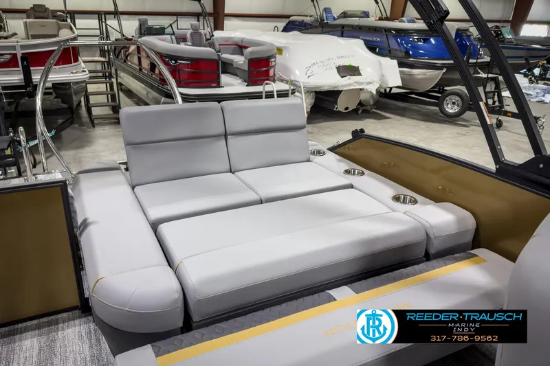 Slide: The Image of 2025 Bennington 22 MSB pontoon boat with luxurious seating in a showroom. - 29