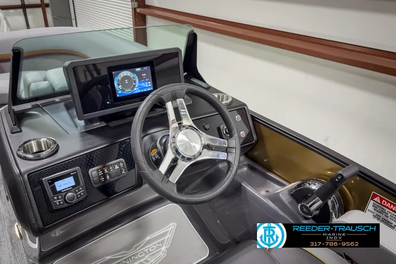 Slide: The Image of 2025 Bennington 22 MSB boat dashboard with steering wheel and digital display. - 30