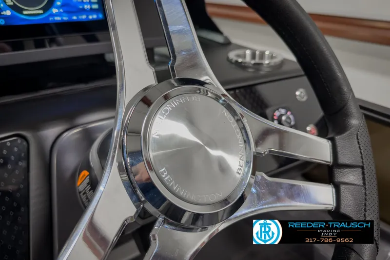 Slide: The Image of Steering wheel of 2025 Bennington 22 MSB boat, featuring sleek chrome design. - 35