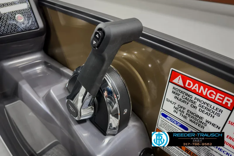Slide: The Image of Close-up of 2025 Bennington 22 MSB throttle control with safety warning labels. - 37