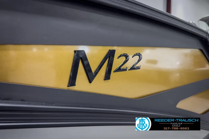 Slide: The Image of 2025 Bennington 22 MSB boat with gold and black detailing. - 48