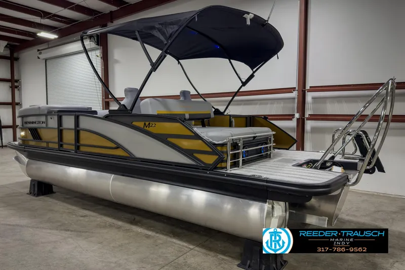 Slide: The Image of 2025 Bennington 22 MSB pontoon boat in a warehouse setting. - 6
