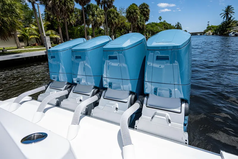 Slide: The Image of 2023 HCB 53 Sueños boat with four blue outboard engines on a sunny day. - 12