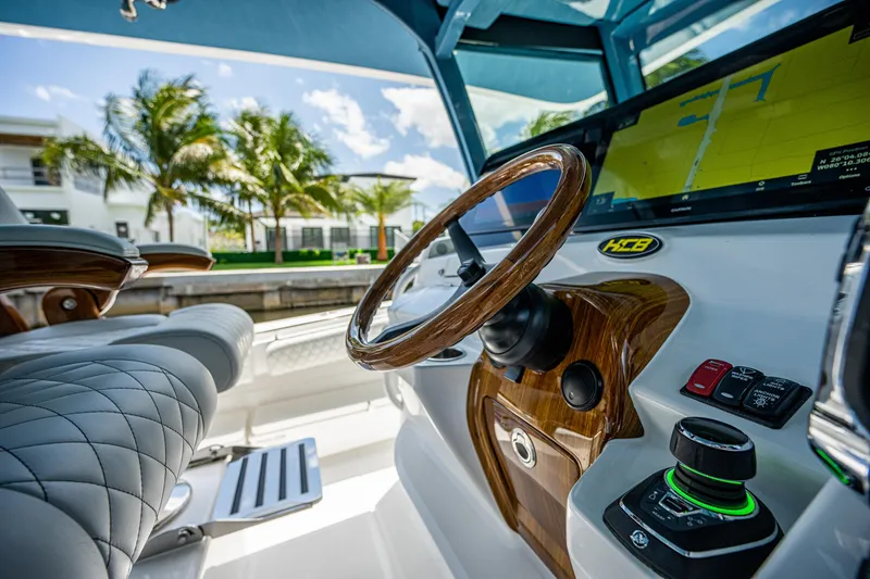 Slide: The Image of Luxurious 2023 HCB 53 Sueños boat interior with elegant steering and controls. - 19