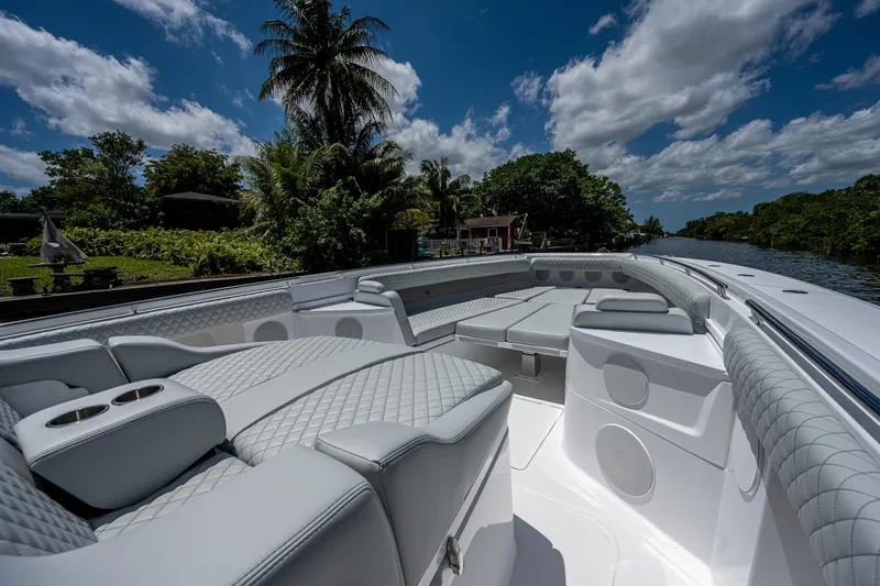 Slide: The Image of Luxurious 2023 HCB 53 Sueños boat interior with plush seating, set against a tropical backdrop. - 25