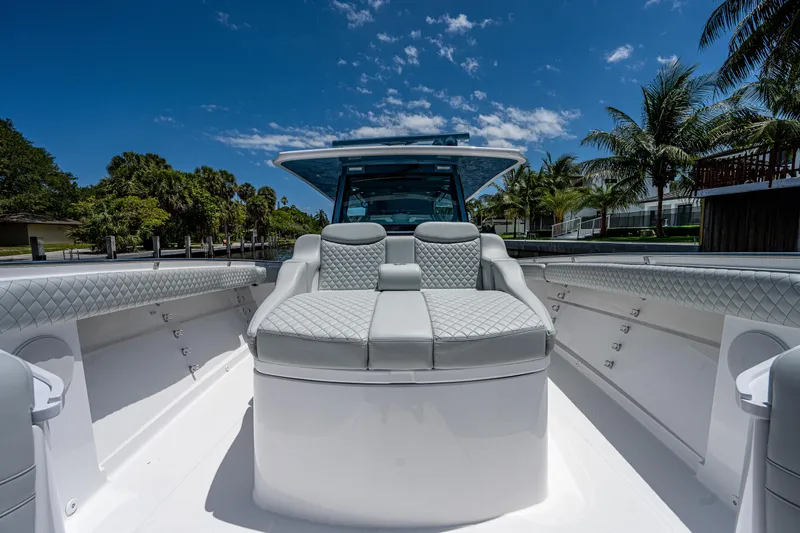 Slide: The Image of 2023 HCB 53 Sueños luxury boat interior with plush seating and clear blue sky. - 26