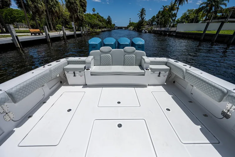 Slide: The Image of 2023 HCB 53 Sueños boat with spacious deck and luxurious seating on a scenic waterway. - 3