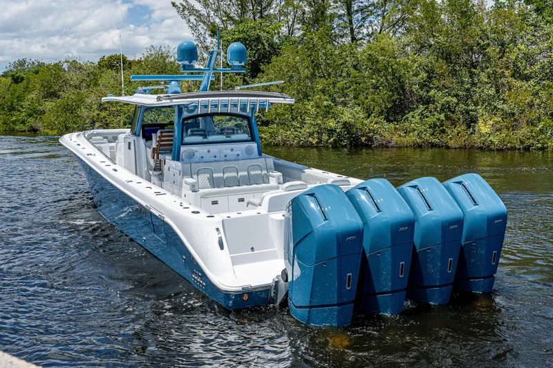 Slide: The Image of 2023 HCB 53 Sueños boat with four powerful engines on a scenic waterway. - 35