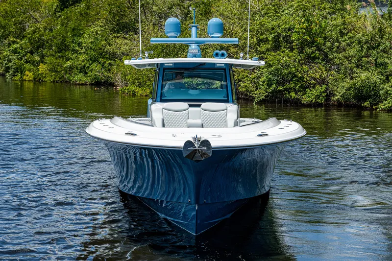 Slide: The Image of 2023 HCB 53 Sueños boat on water, surrounded by lush greenery. - 38