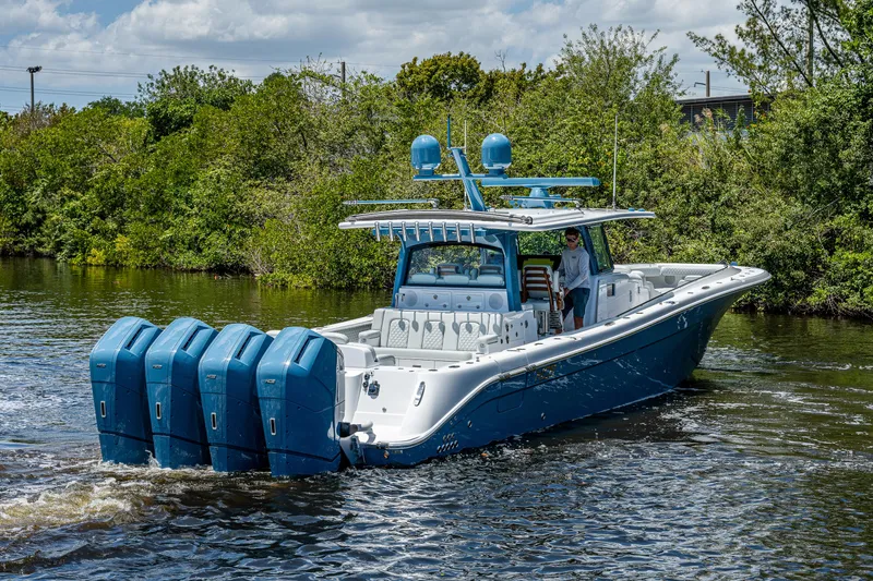 Slide: The Image of 2023 HCB 53 Sueños boat with multiple engines cruising on a river. - 39