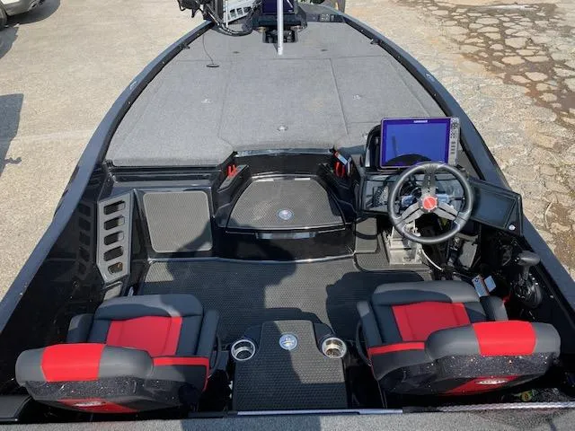 Slide: The Image of 2024 iKon LX20 boat interior with red and black seats, steering wheel, and navigation screen. - 3