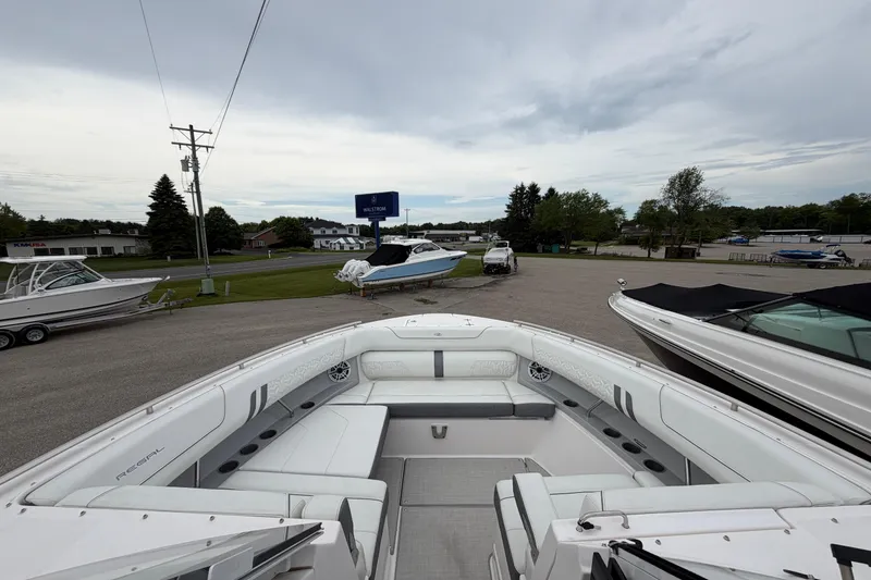 Slide: The Image of 2025 Regal LS36 boat with spacious seating at a marina. - 14