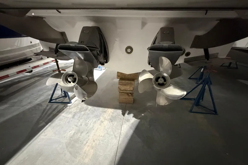 Slide: The Image of 2025 Regal LS36 boat propellers on stands in a garage setting. - 27