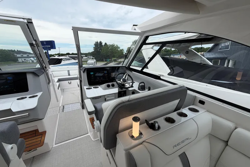 Slide: The Image of Interior of 2025 Regal LS36 boat, featuring modern helm and seating area. - 9