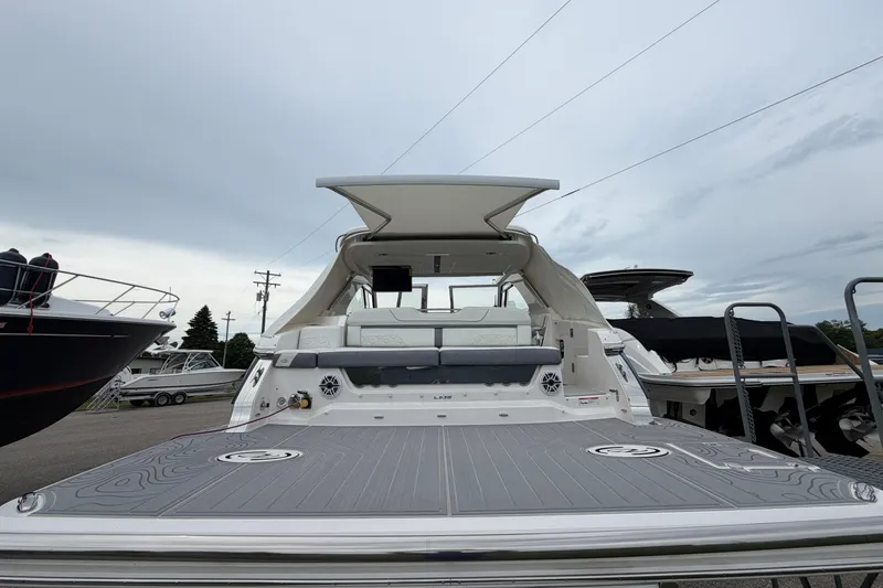 Slide: The Image of 2025 Regal LS36 luxury boat with spacious deck and modern design, docked at marina. - 4