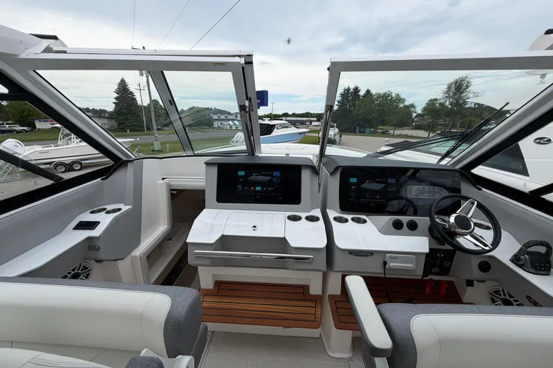 Slide: The Image of Interior view of 2025 Regal LS36 boat cockpit with modern controls and steering wheel. - 10