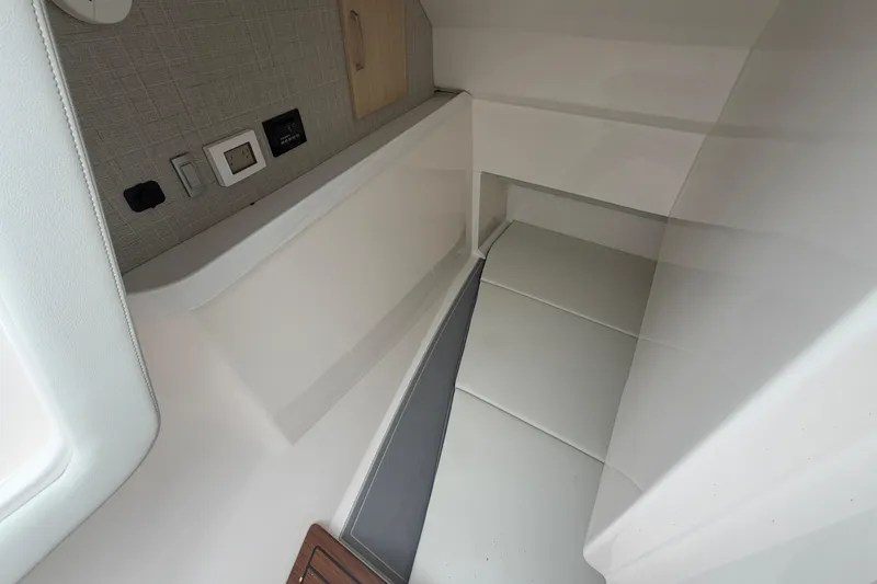 Slide: The Image of Interior cabin of 2025 Regal LS36 boat with modern design and electrical outlets. - 15