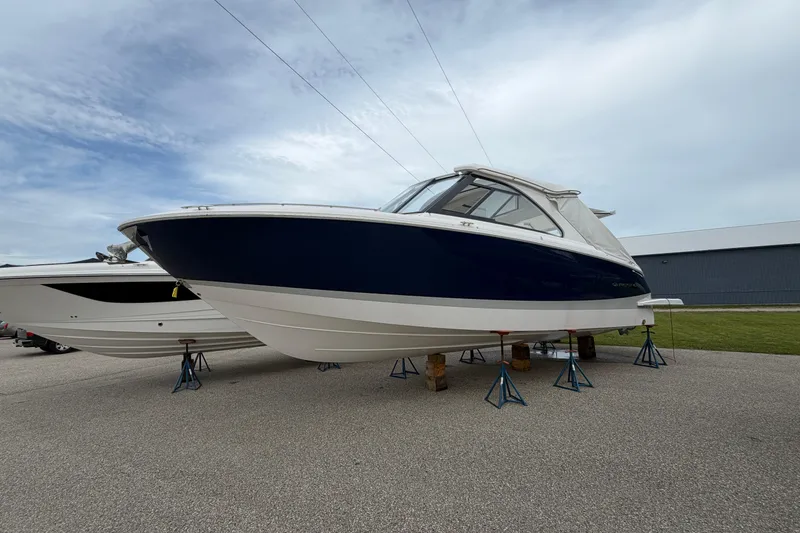 Slide: The Image of 2025 Regal LS36 boat on stands, displayed outdoors under a cloudy sky. - 0