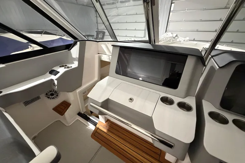 Slide: The Image of Interior of 2025 Regal LS36 boat with modern dashboard and wooden flooring. - 21
