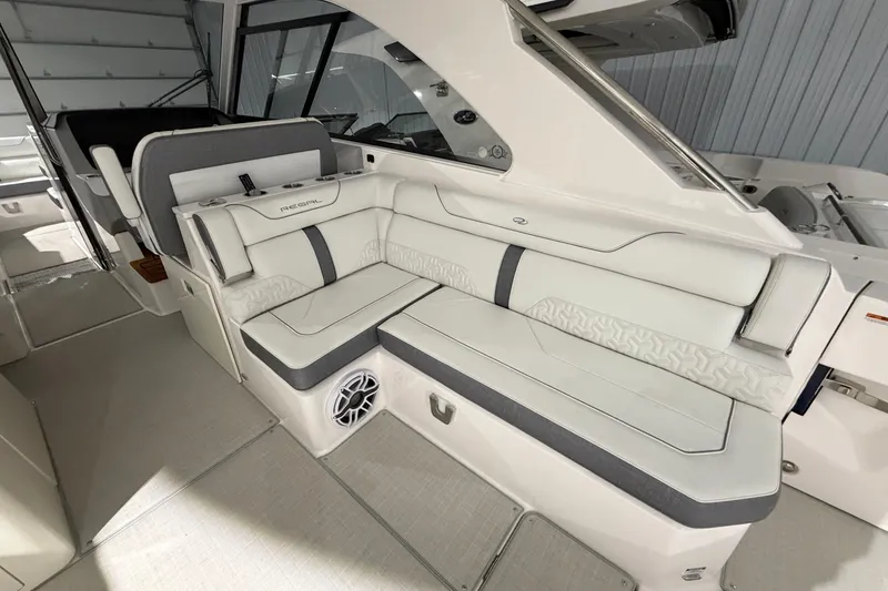 Slide: The Image of 2025 Regal LS36 boat interior with luxurious white seating and modern design. - 24