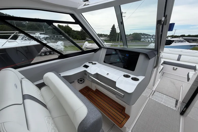 Slide: The Image of 2025 Regal LS36 boat interior with modern helm, touchscreen display, and luxurious seating. - 12