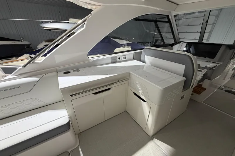 Slide: The Image of Interior of 2025 Regal LS36 boat with modern seating and sleek design. - 22