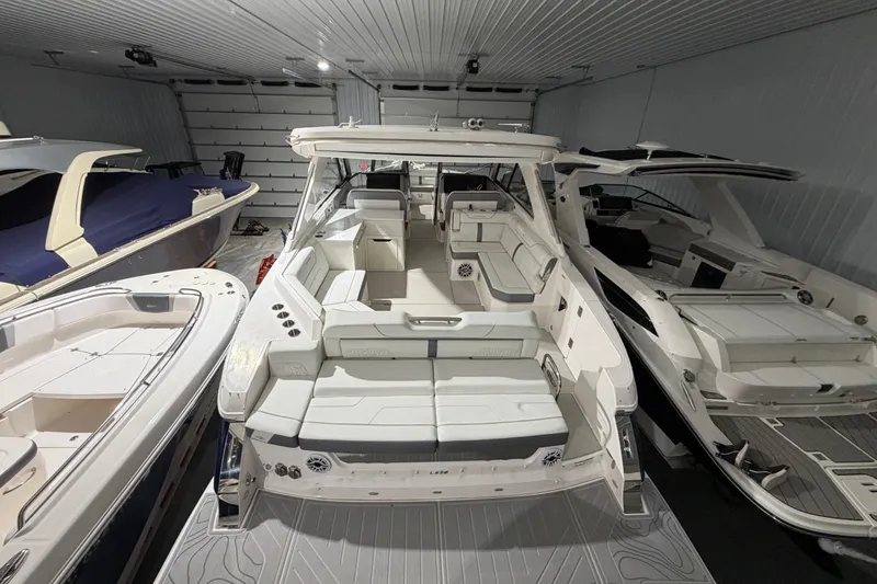 Slide: The Image of 2025 Regal LS36 luxury boat in a showroom, showcasing sleek design and spacious seating. - 26