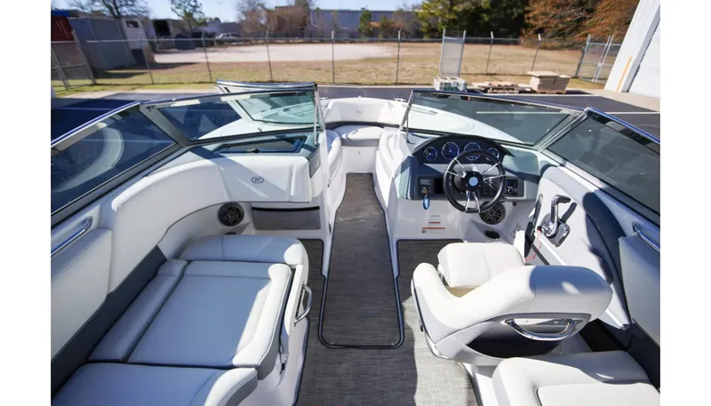 Slide: The Image of 2018 Cobalt 220S boat interior with white seating and modern dashboard. - 12