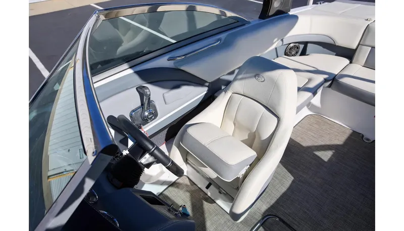 Slide: The Image of 2018 Cobalt 220S boat interior with steering wheel and seating. - 16