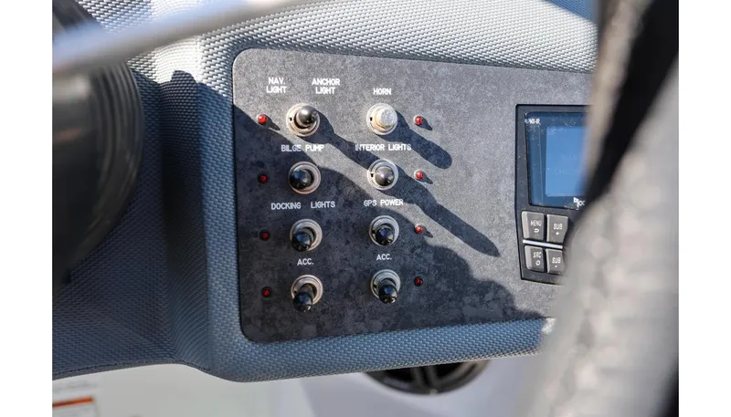 Slide: The Image of Control panel of a 2018 Cobalt 220S boat with switches and display. - 23