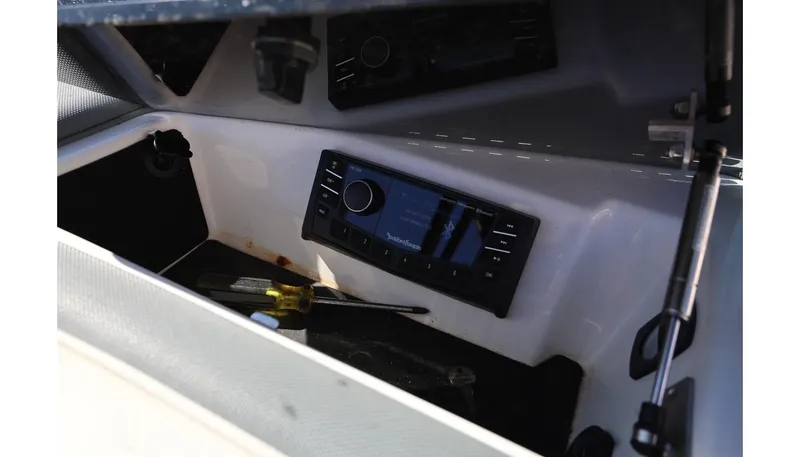 Slide: The Image of 2018 Cobalt 220S boat dashboard with stereo system and tools. - 24
