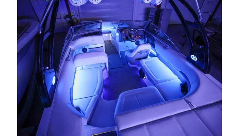 Slide: The Image of 2018 Cobalt 220S boat interior with blue LED lighting and luxurious seating. - 26