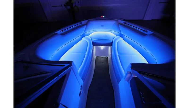 Slide: The Image of 2018 Cobalt 220S boat interior with blue LED lighting, showcasing luxurious seating. - 27