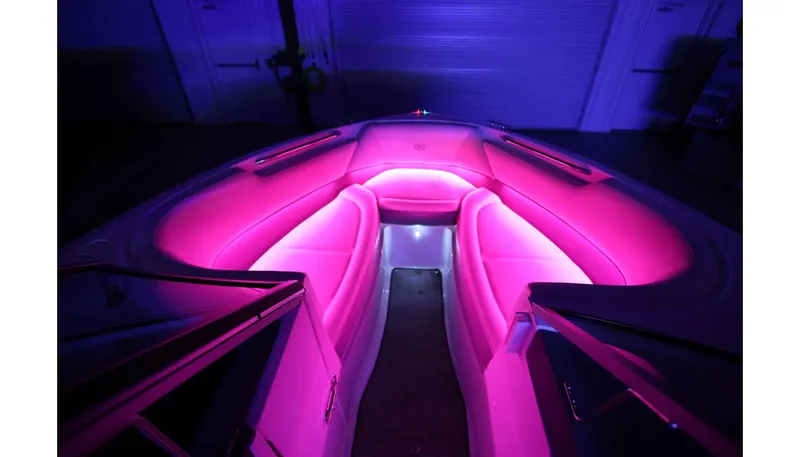 Slide: The Image of 2018 Cobalt 220S boat interior with vibrant pink LED lighting. - 28