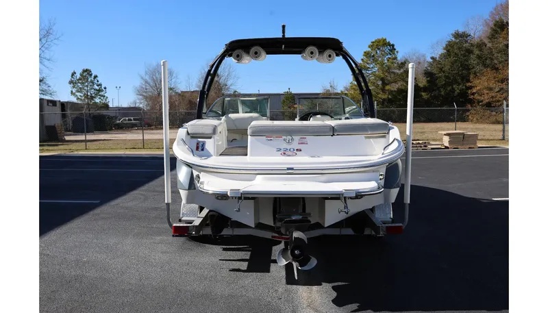 Slide: The Image of 2018 Cobalt 220S boat, rear view, parked outdoors on asphalt. - 3