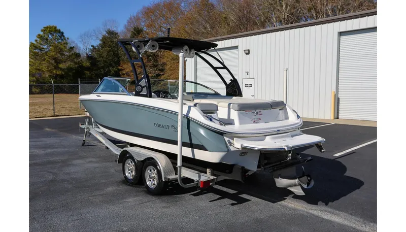 Slide: The Image of 2018 Cobalt 220S boat on trailer, parked outdoors near a building. - 4