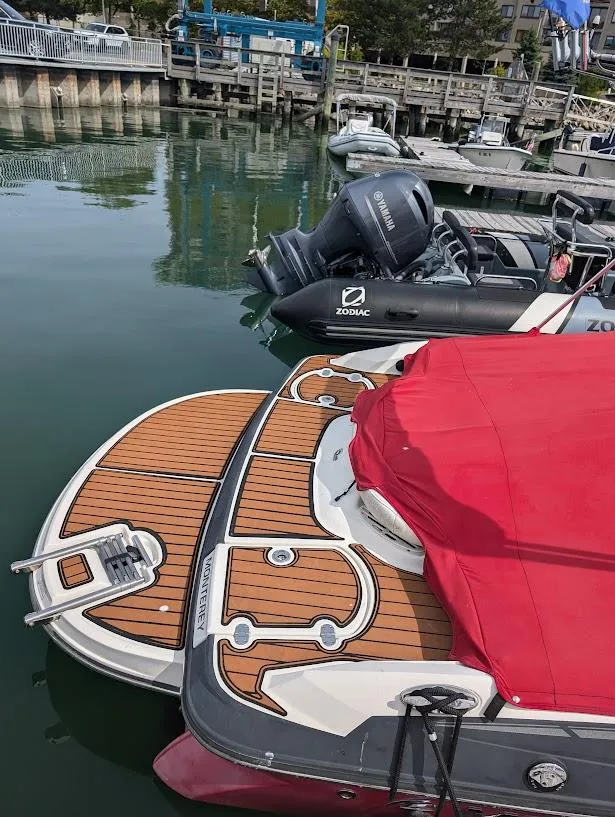 Slide: The Image of 2013 Monterey 204FS boat with red cover docked at marina. - 4