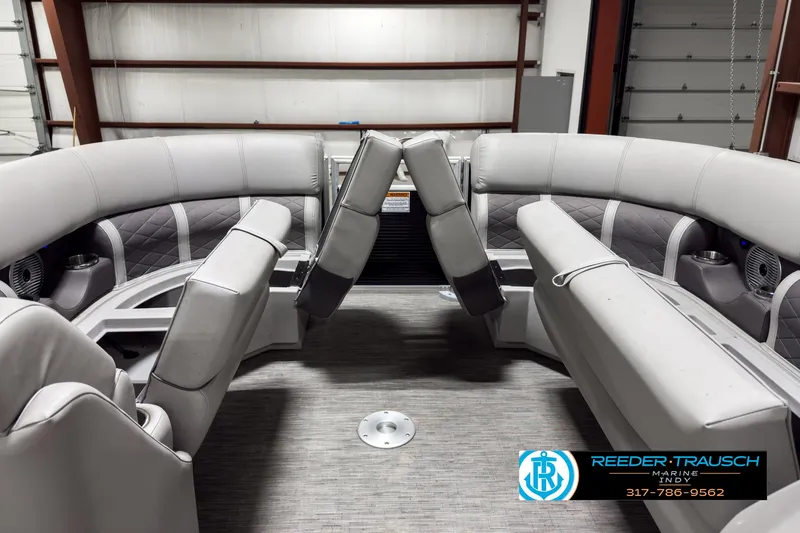 Slide: The Image of 2022 Bennington 23 LSR pontoon boat interior with gray seating in a showroom. - 19