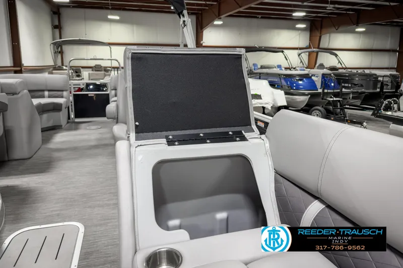 Slide: The Image of 2022 Bennington 23 LSR pontoon boat interior with storage compartment and seating. - 21