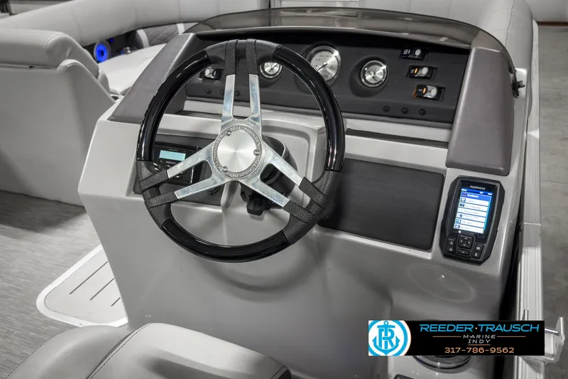 Slide: The Image of 2022 Bennington 23 LSR boat dashboard with steering wheel and control panel. - 24