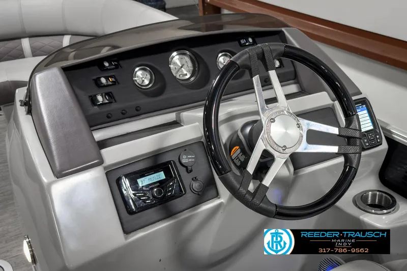 Slide: The Image of 2022 Bennington 23 LSR boat dashboard with steering wheel and control panel. - 25