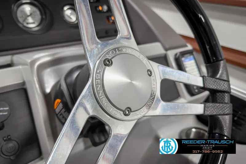 Slide: The Image of Close-up of 2022 Bennington 23 LSR steering wheel with dashboard controls. - 26