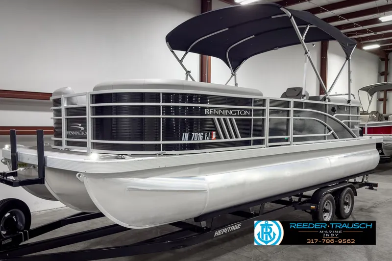 Slide: The Image of 2022 Bennington 23 LSR pontoon boat on trailer in indoor showroom. - 3